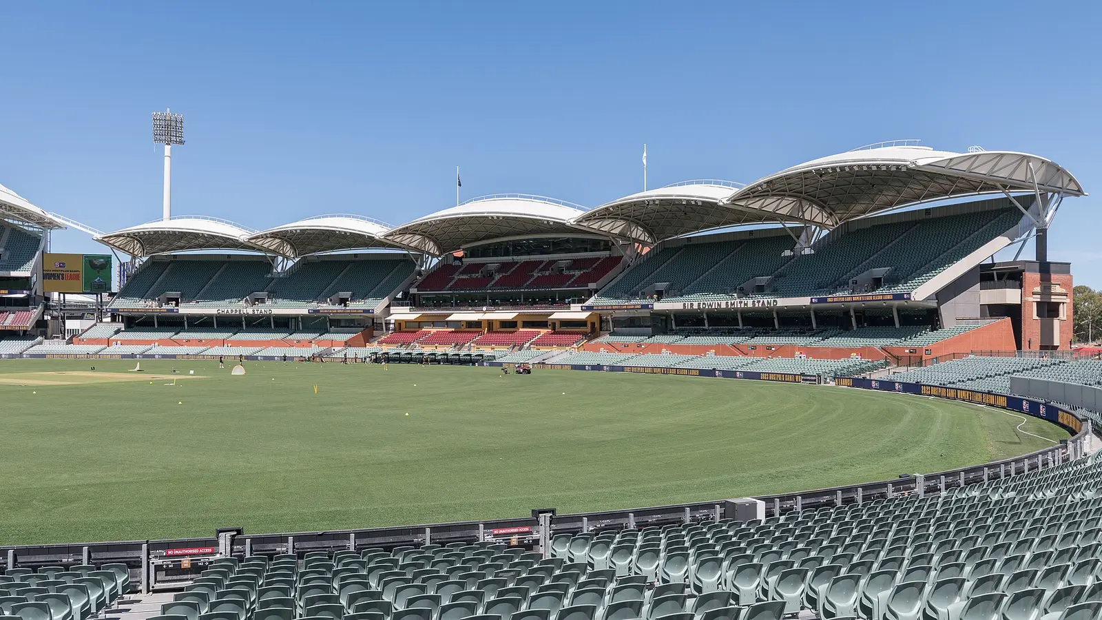 The curved roofs of the eastern stands above the green playing surface at Adelaide Oval
