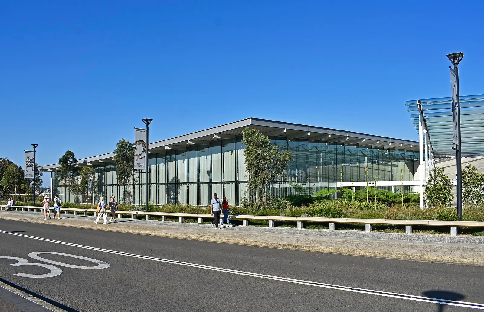 The glass and sandstone-toned new Naala Badu building of the Art Gallery of New South Wales on a sunny day