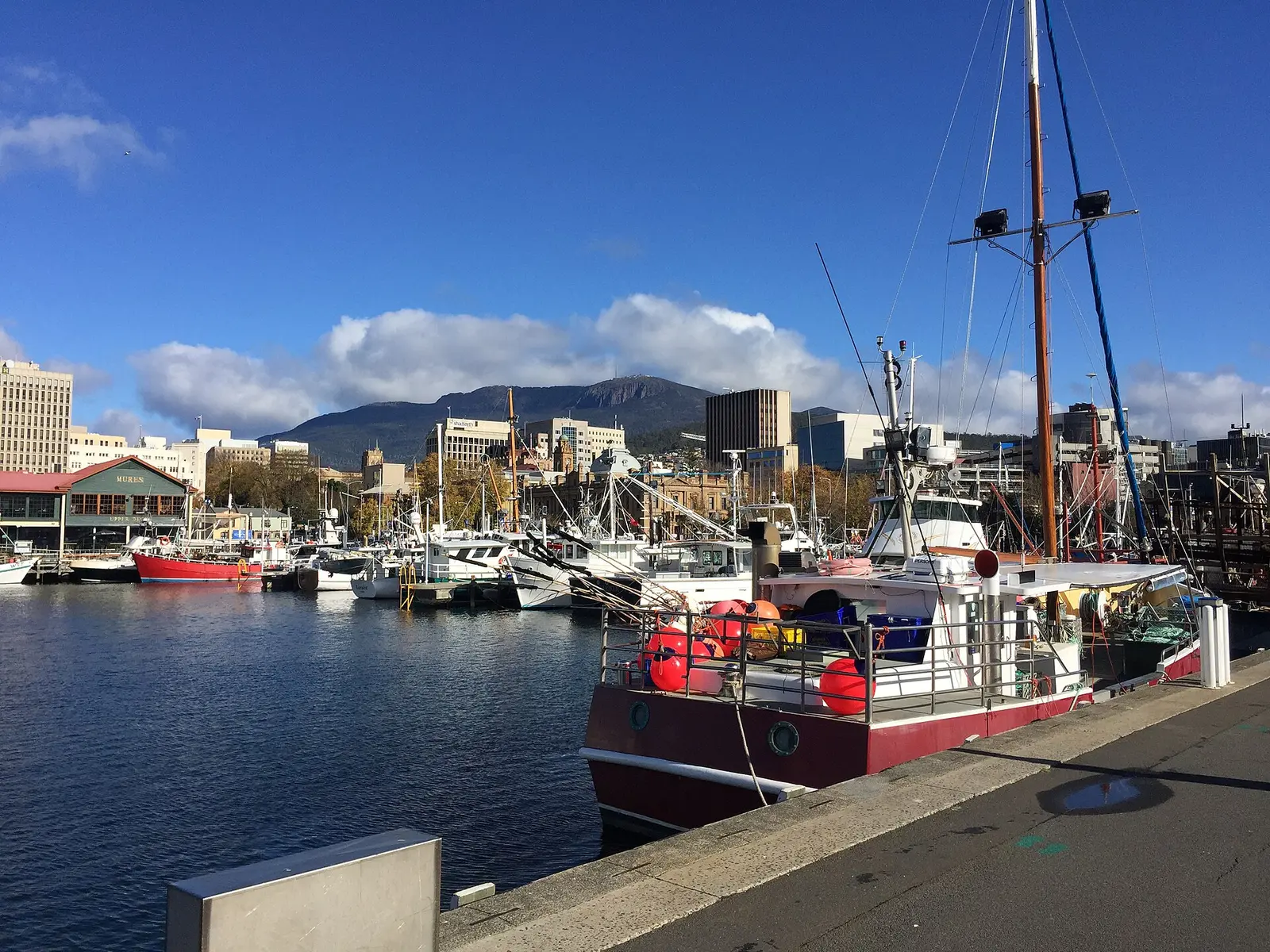 Boats moored on the Hobart waterfront with the city and mountain behind