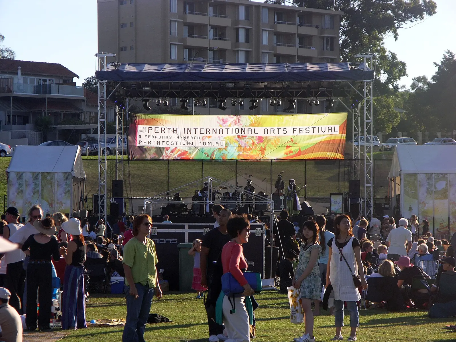 Crowds on the lawn in front of a stage under the Perth International Arts Festival banner, 2007