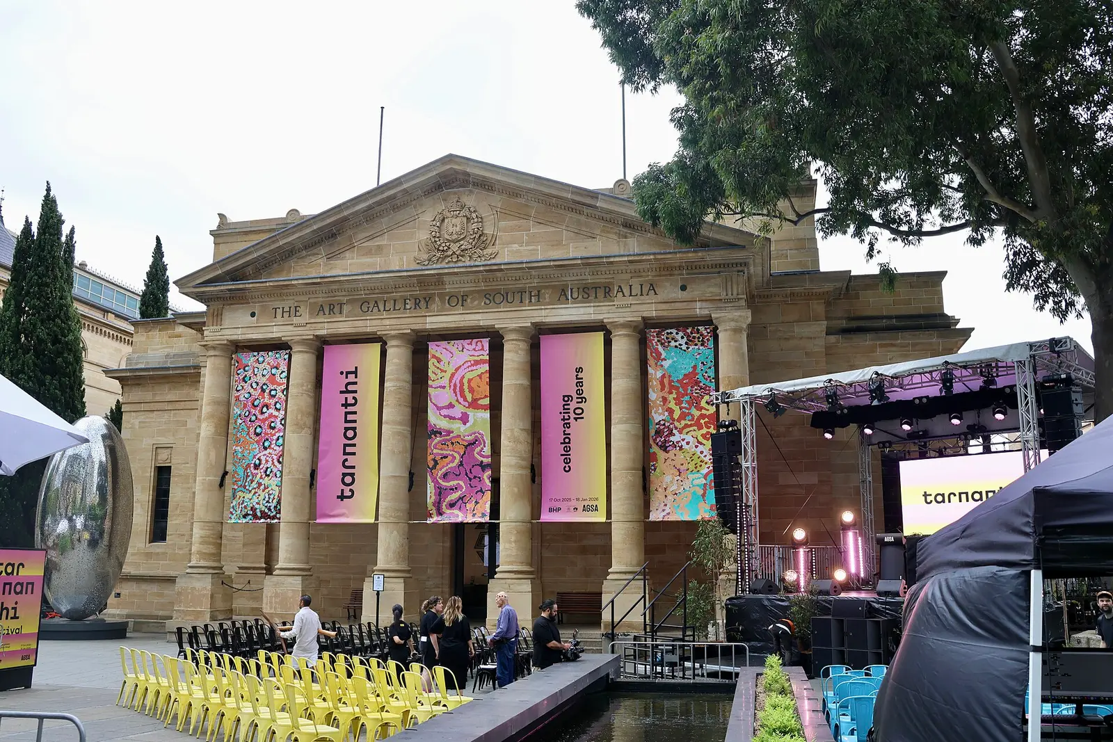 Tarnanthi banners hung between the columns of the Art Gallery of South Australia with a stage set up outside